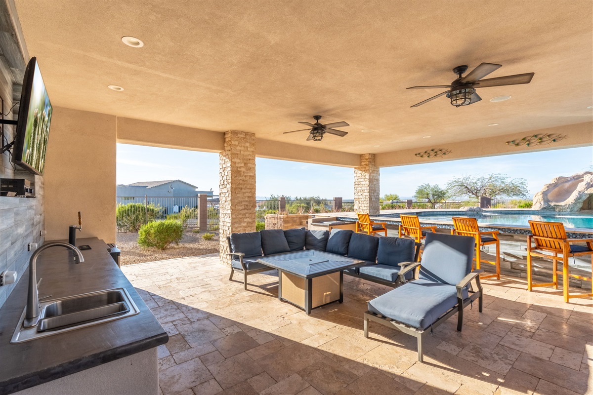 Resort-style covered patio with sectional seating and mountain views designed for sunset conversations and evening gatherings