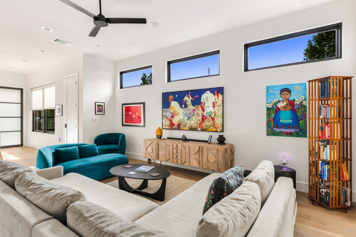Bold, colorful artwork sets a playful tone in this open-concept living room.