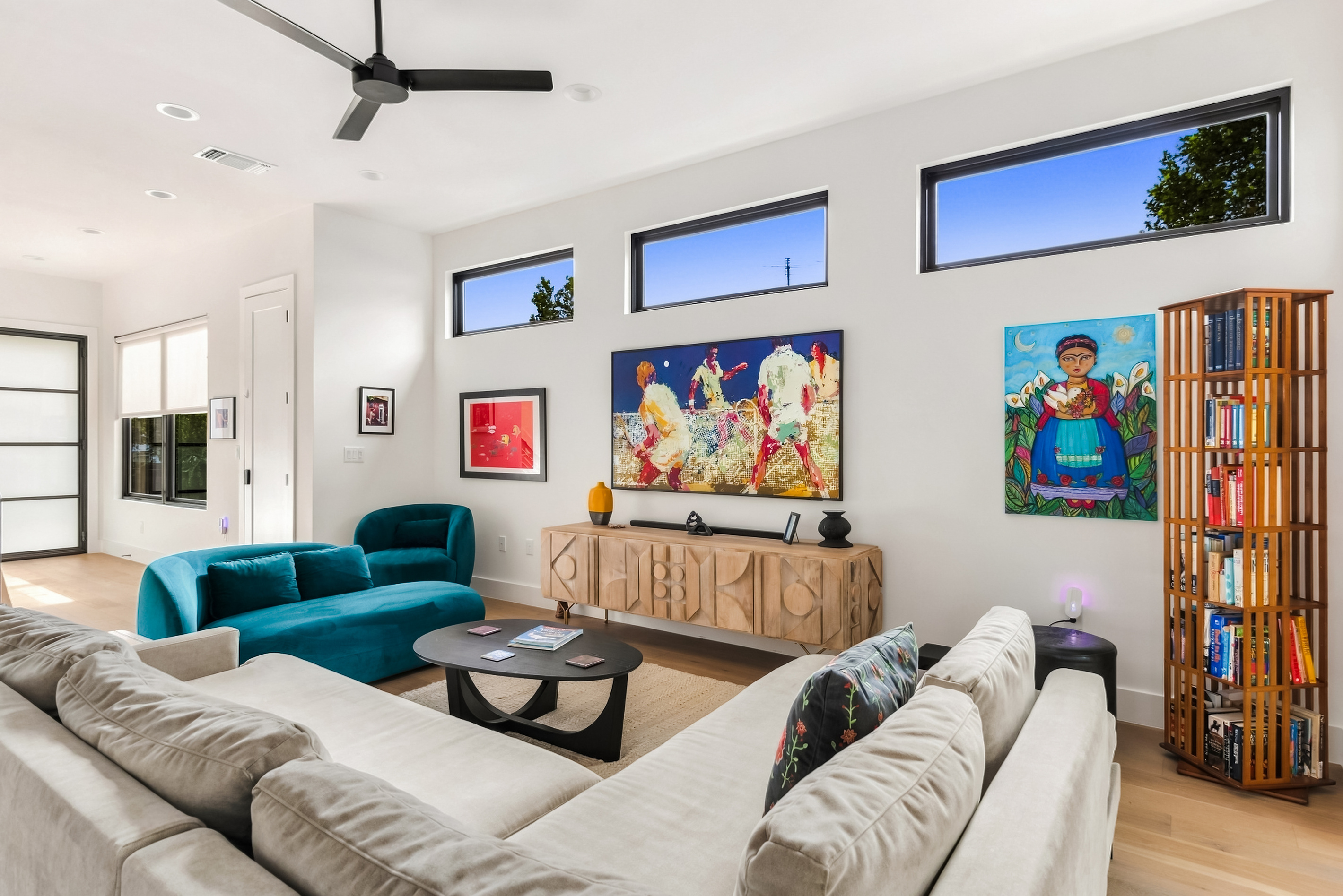 Bold, colorful artwork sets a playful tone in this open-concept living room.