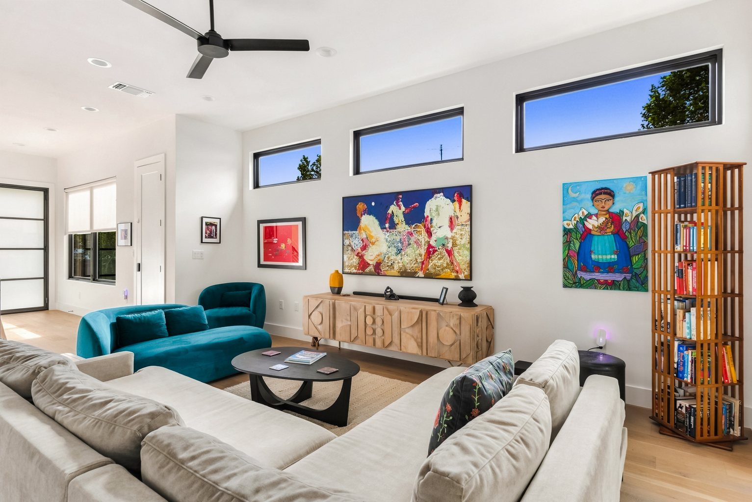 Bold, colorful artwork sets a playful tone in this open-concept living room.