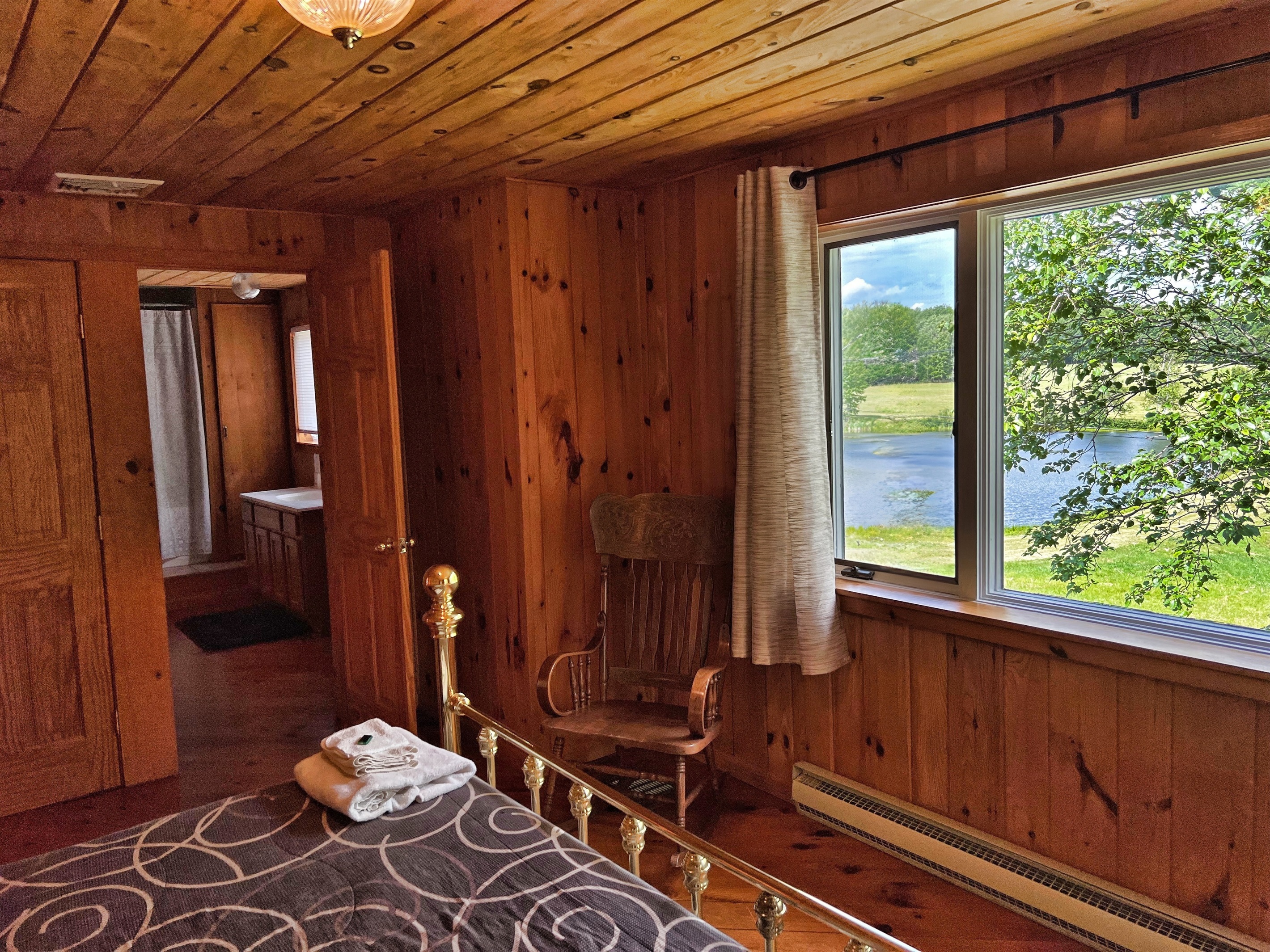 Bedroom #2 2nd floor - Beautiful pond view from primary king bedroom #2.  View into the full en-suite bathroom.