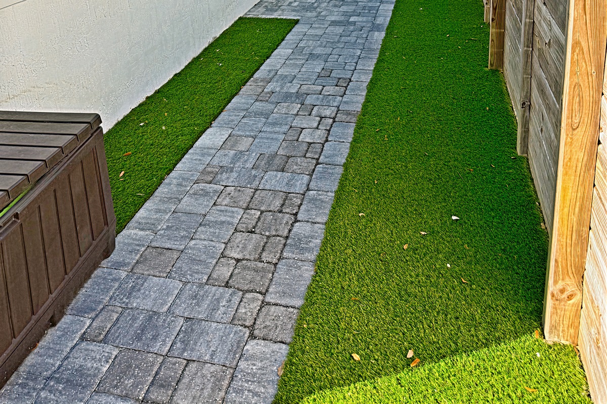 side pathway leads to outdoor shower and beach supplies