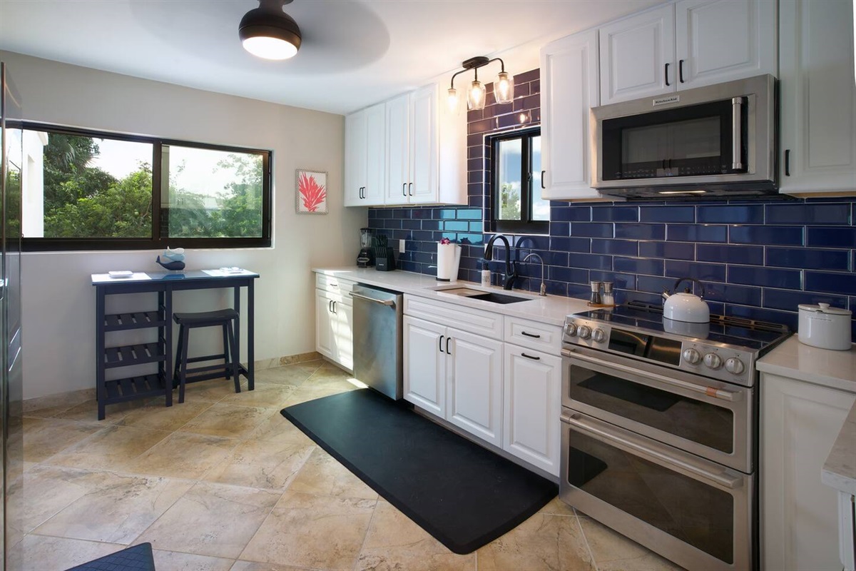 Ceiling fan to keep that island breeze moving while you prepare your meals with ease in this fully-equipped, contemporary kitchen. This fully stocked kitchen contains everything you could possibly need during your stay.