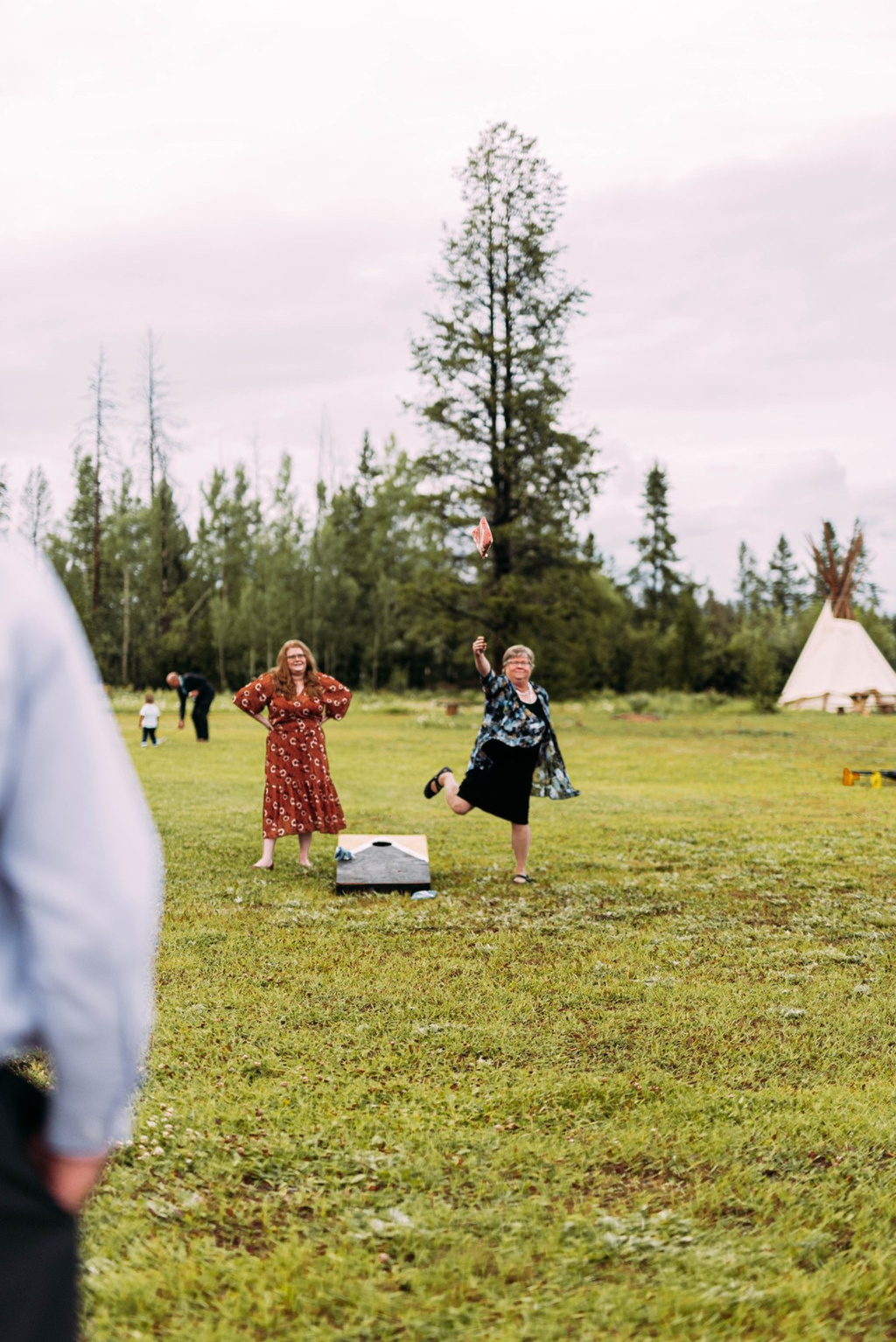 Guests playing lawn games by the tent