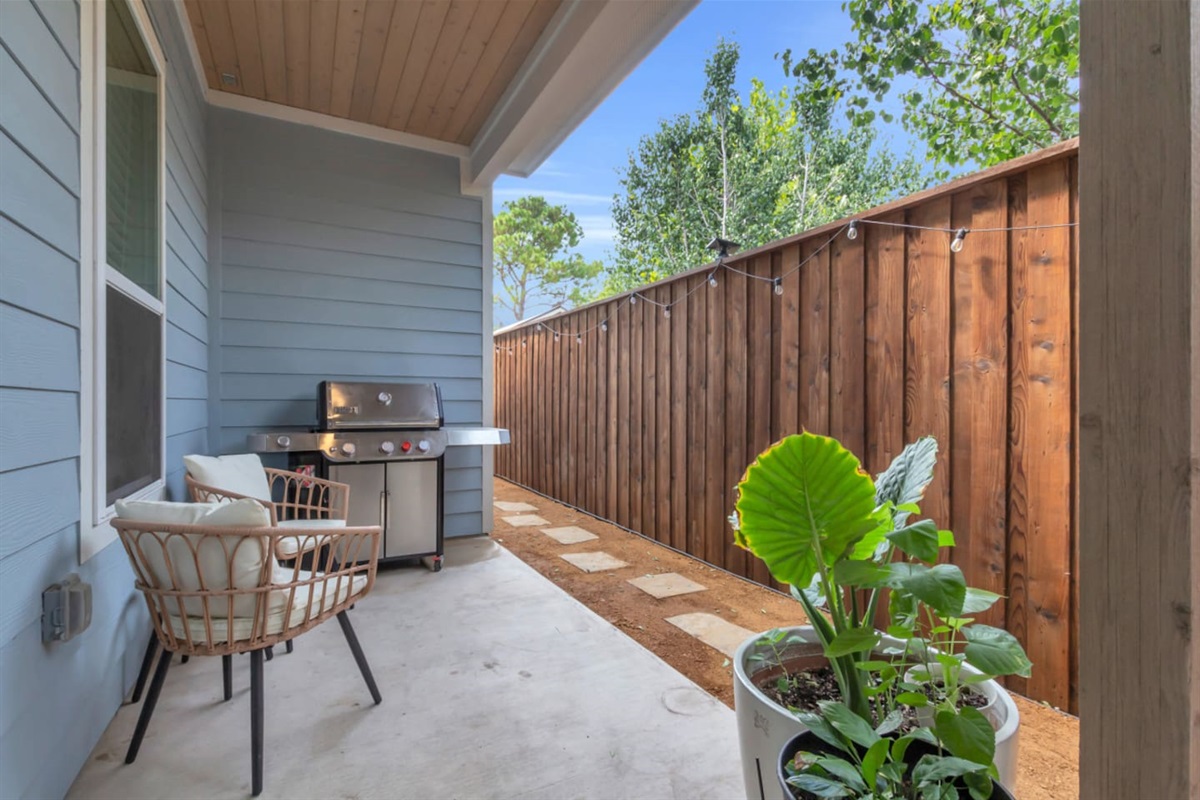 Back patio with shaded seating and a gas BBQ grill