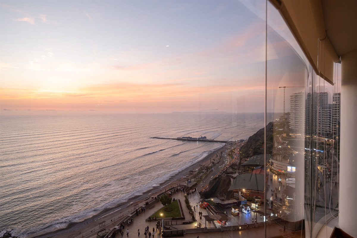 (Photo taken from apartment in summer) View from the living room at evening. World-Class Sunsets: Your private front-row seat to the most magical golden hours in Lima.