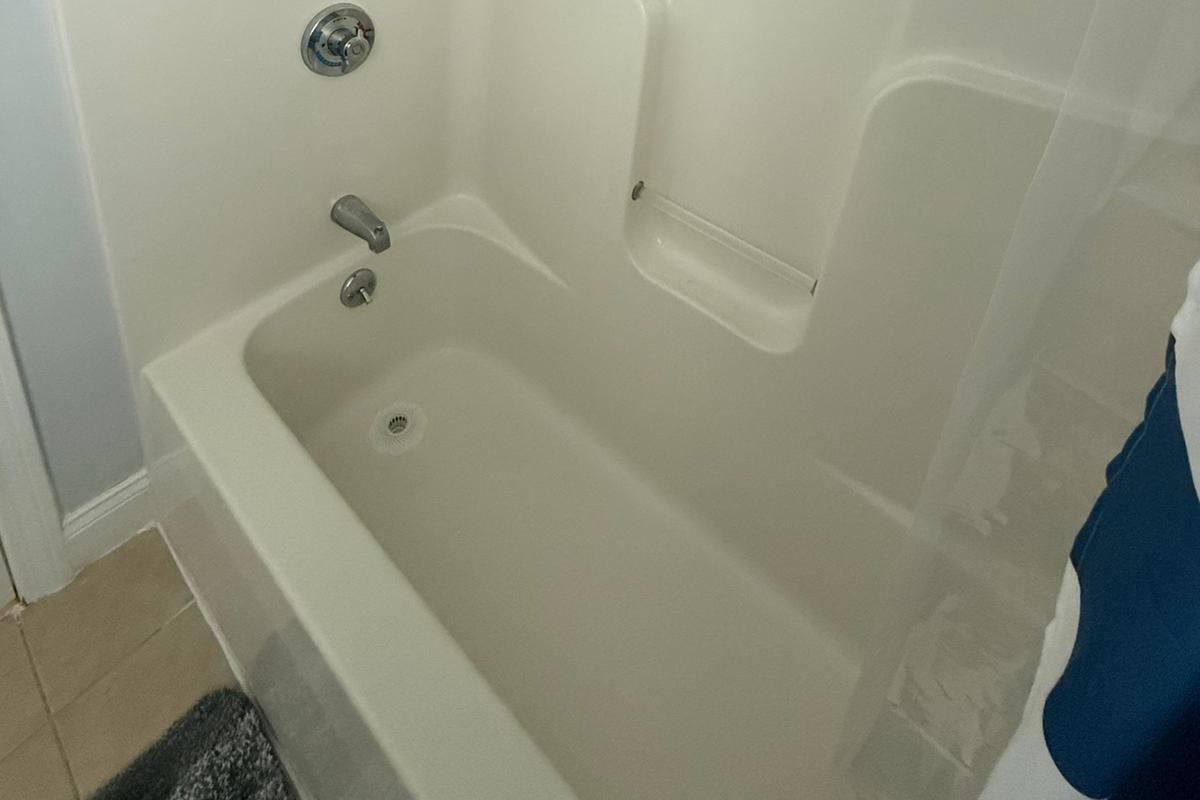 Full bathroom shower/tub with wash/conditioner/shampoo