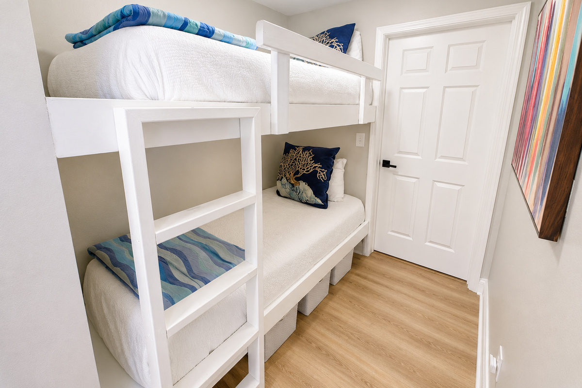 Bunk room with barn door and bathroom access