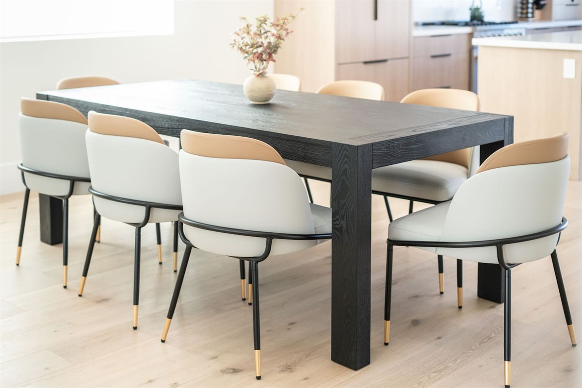 Neutral tones paired with clean lines highlight the dining area’s contemporary aesthetic.