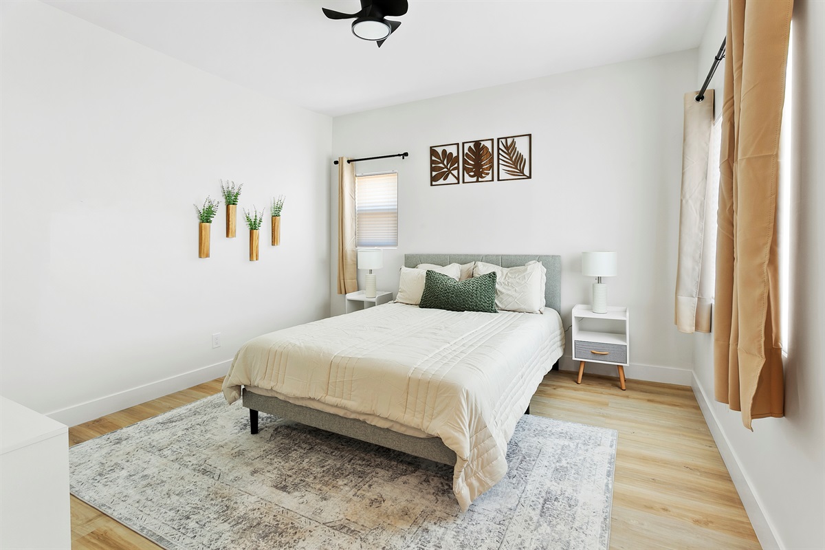 Well- appointed bedroom with queen bed, bright and spacious with blinds and room darkening shades