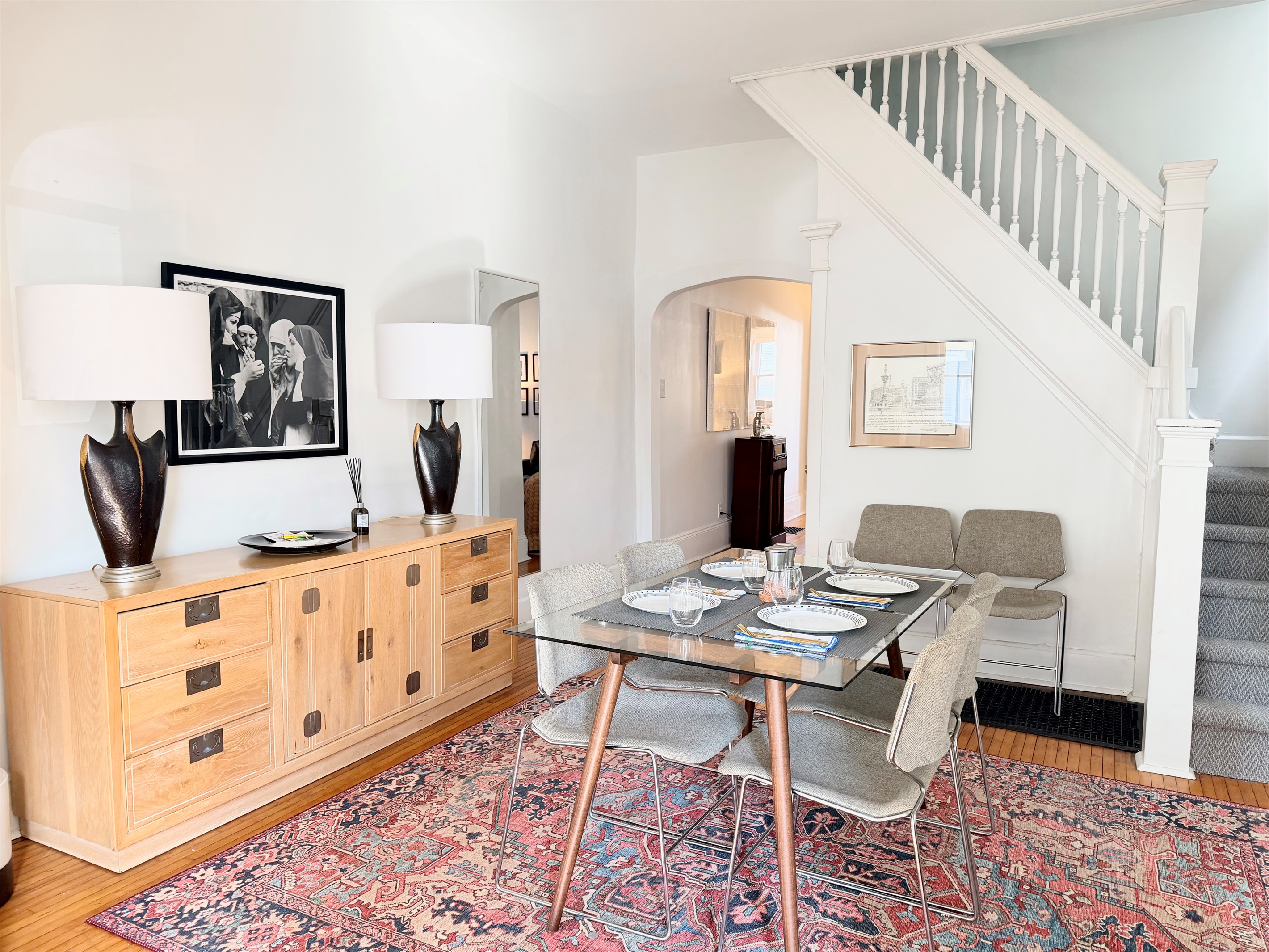 Mid-century modern pieces anchor the dining room, blending vintage character with playful accents, comfortable seating for four and extra cozy seating for up to six.