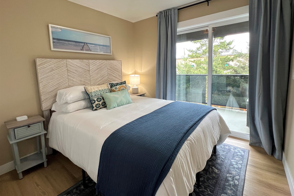 33 Villa B second bedroom — its own private deck access, king bed, and morning views.