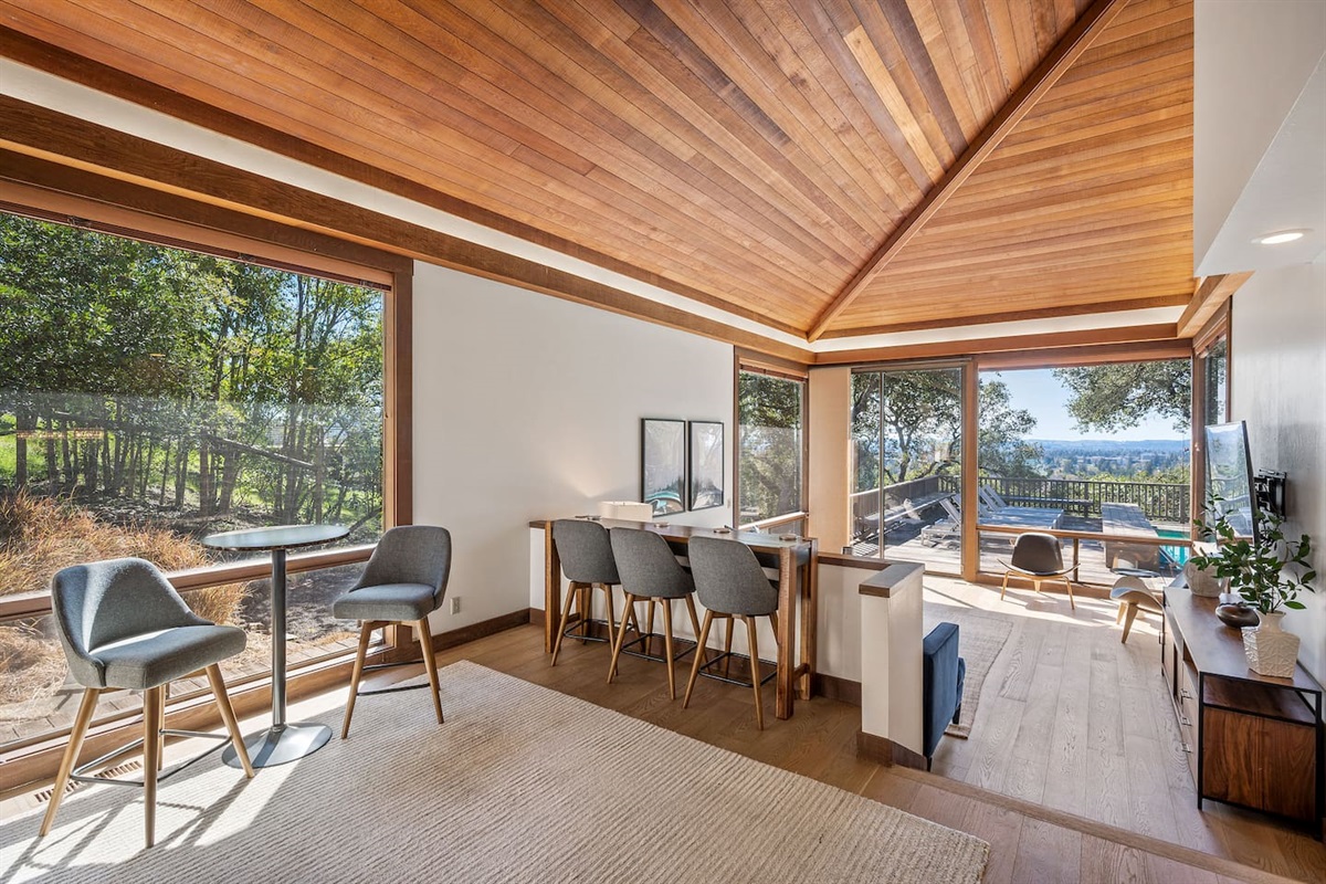Haven is special for its large indoor and outdoor communal spaces. Two-level living room with a 80" 4k TV sits next to the kitchen and dining room. Both rooms open to the back deck with the pool, hot tub, and outdoor dining.