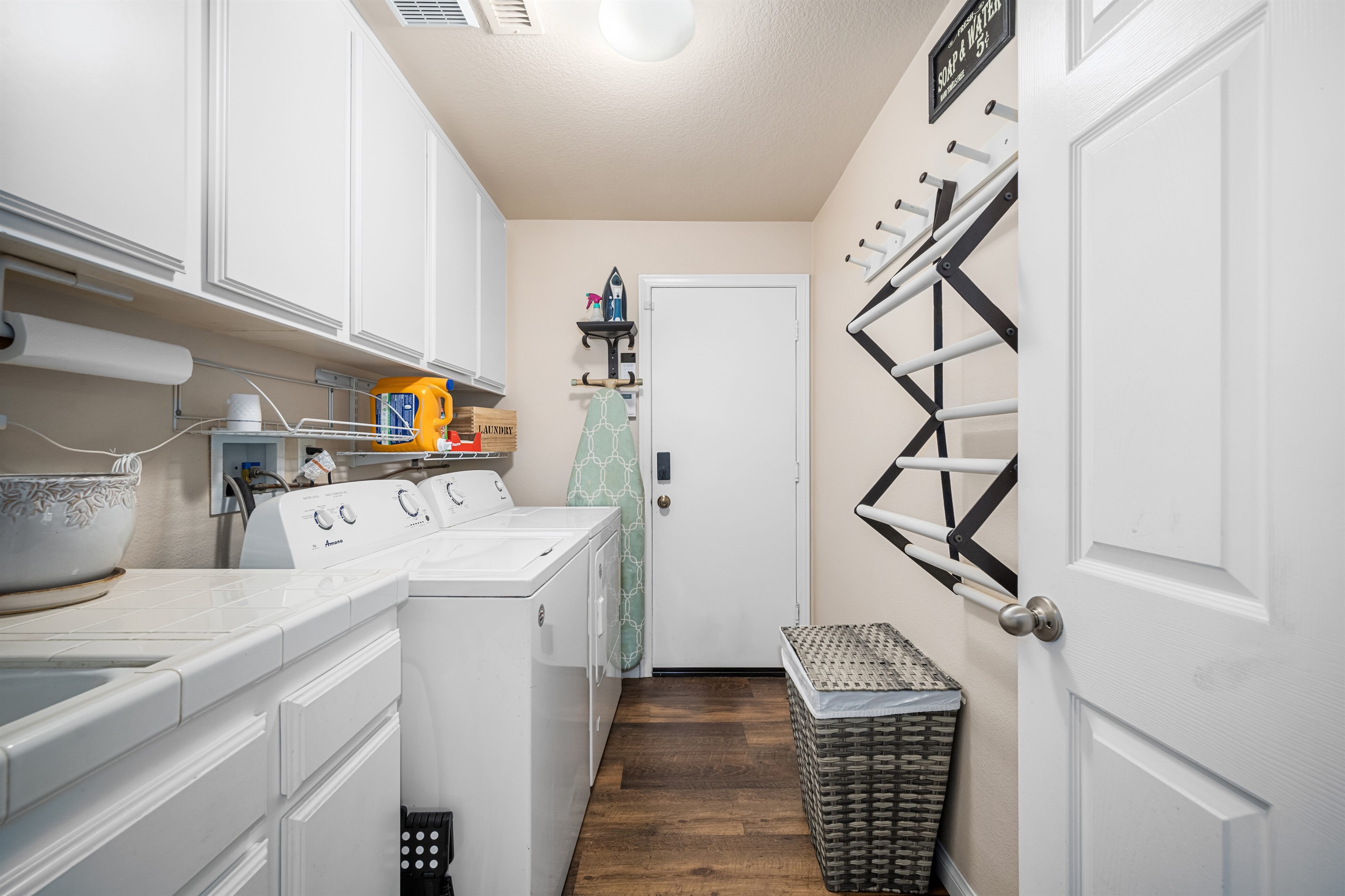 Laundry Room, (washer, dryer, sink, ironing board and drying rack)