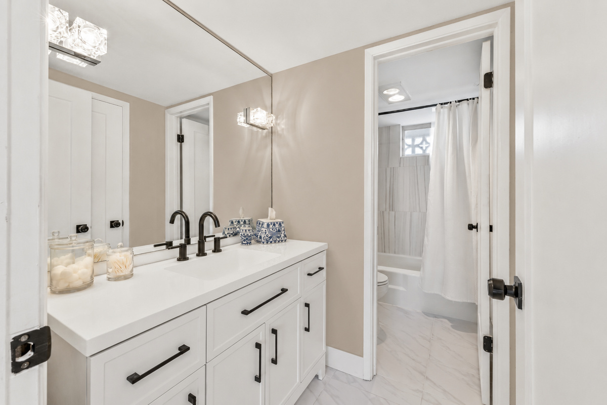 Second bathroom featuring a bathtub and shower.