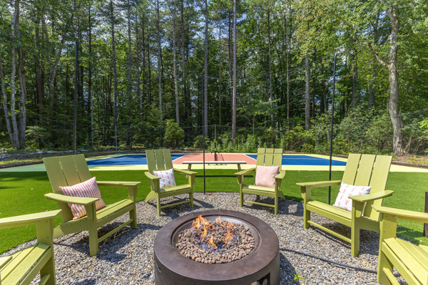A cozy outdoor seating space set up for comfort and connection, ideal for enjoying refreshments and sharing snacks while spending time together.