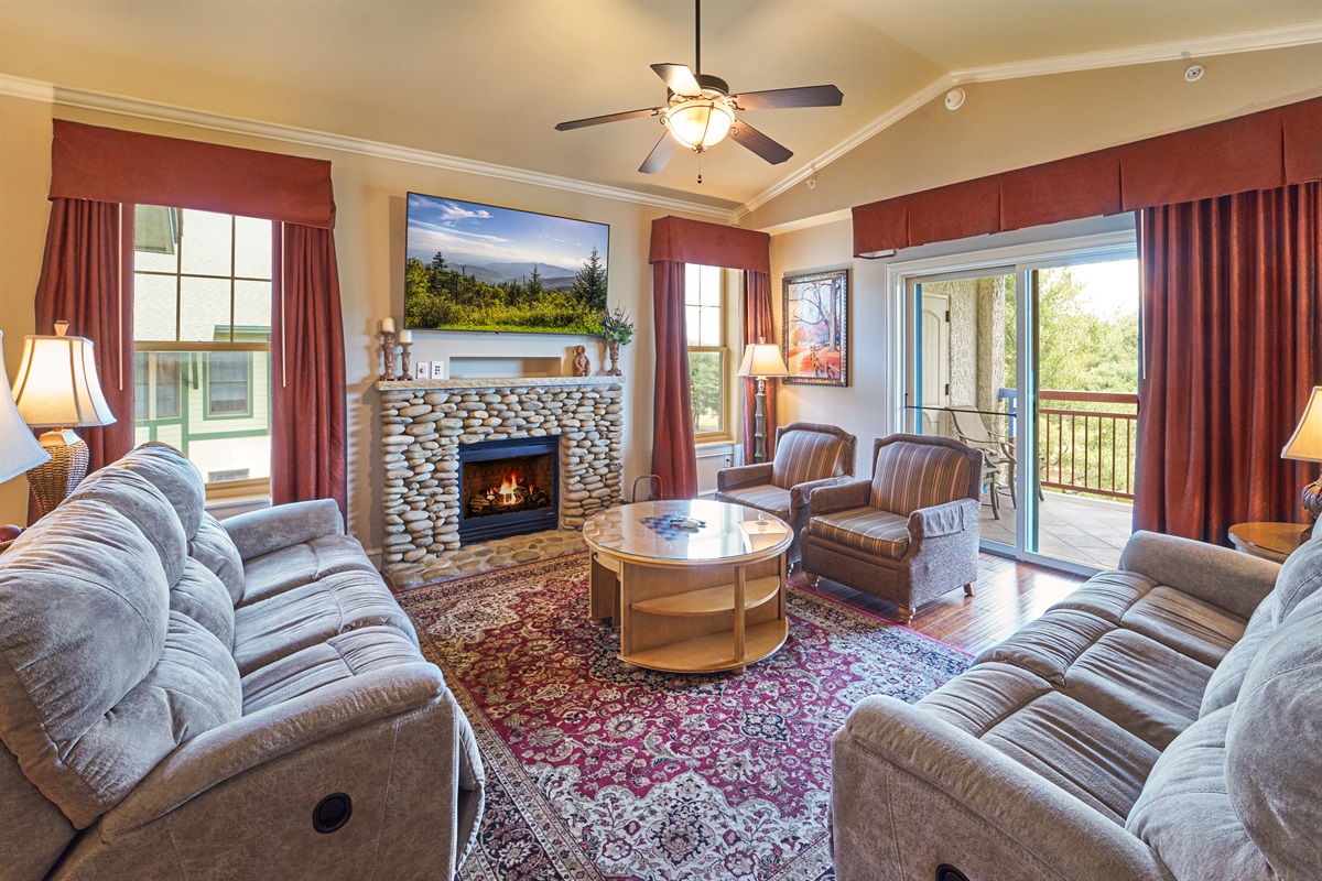 Cozy Living Area with fireplace 70"TV Comfortable Sofas with Recliners On Each End
