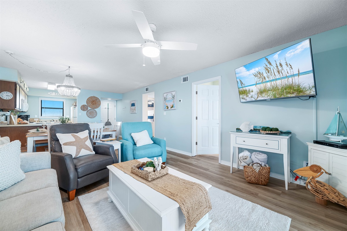 Light and airy living space featuring coastal-inspired decor and a seamless flow between the living and dining areas.