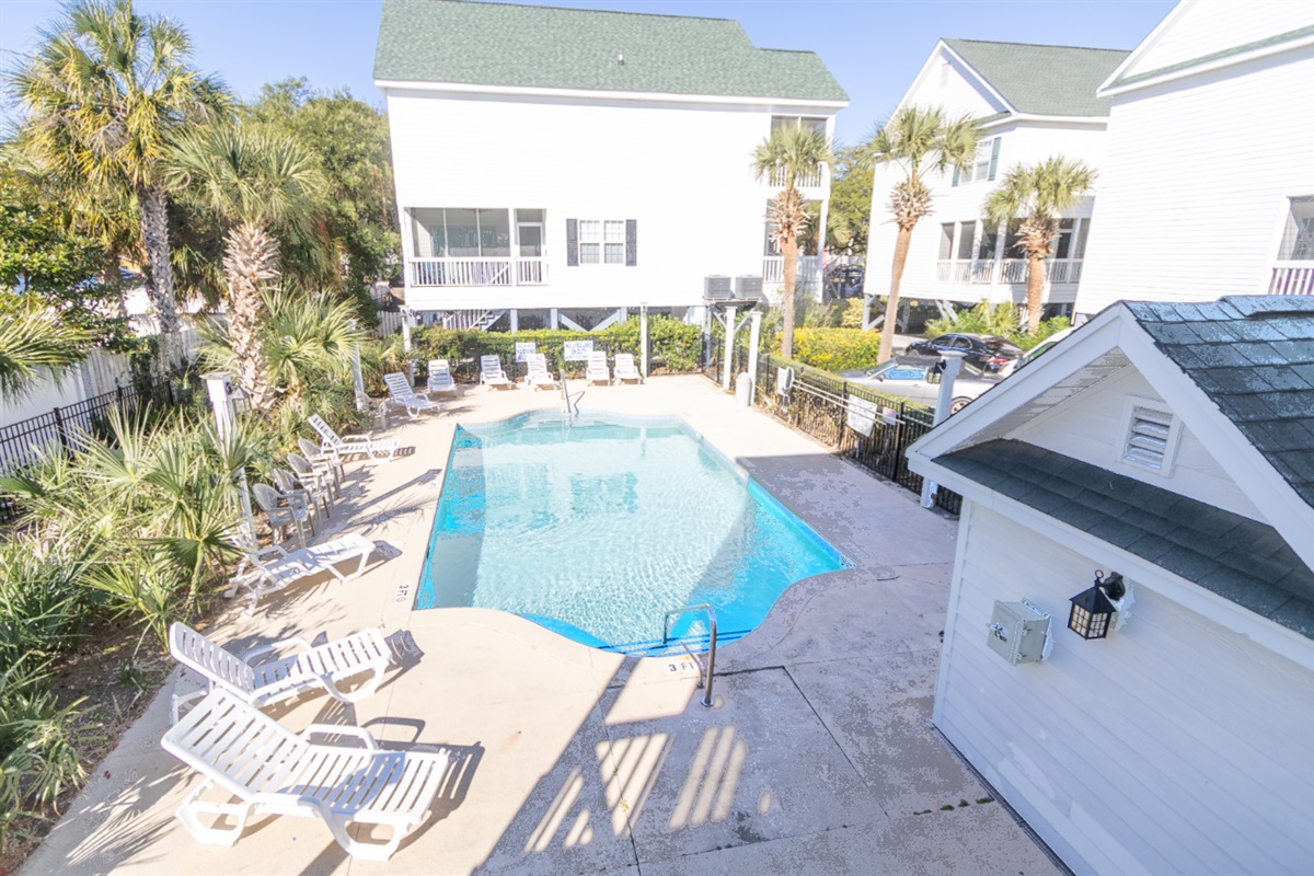 Welcome to Hola Beaches! Unwind in the serene poolside oasis, surrounded by swaying palms and comfy loungers