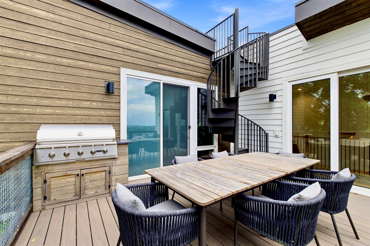 Private deck w/ a gas grill, dining table & outdoor seating — ideal for an al fresco cookout.
