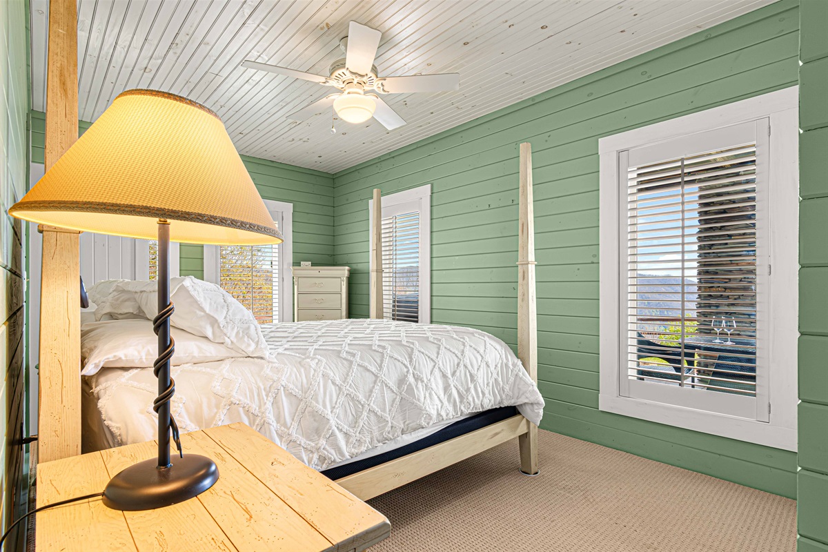 Downstairs Queen Bedroom 4: Experience serenity in this well-lit room with mountain views and rustic charm!
