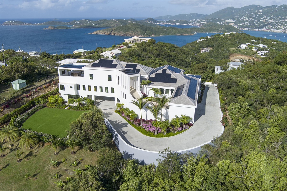 Aerial photo of the back of property with large turf backyard. The bunk bedroom sliding doors open up to the turfed backyard space.