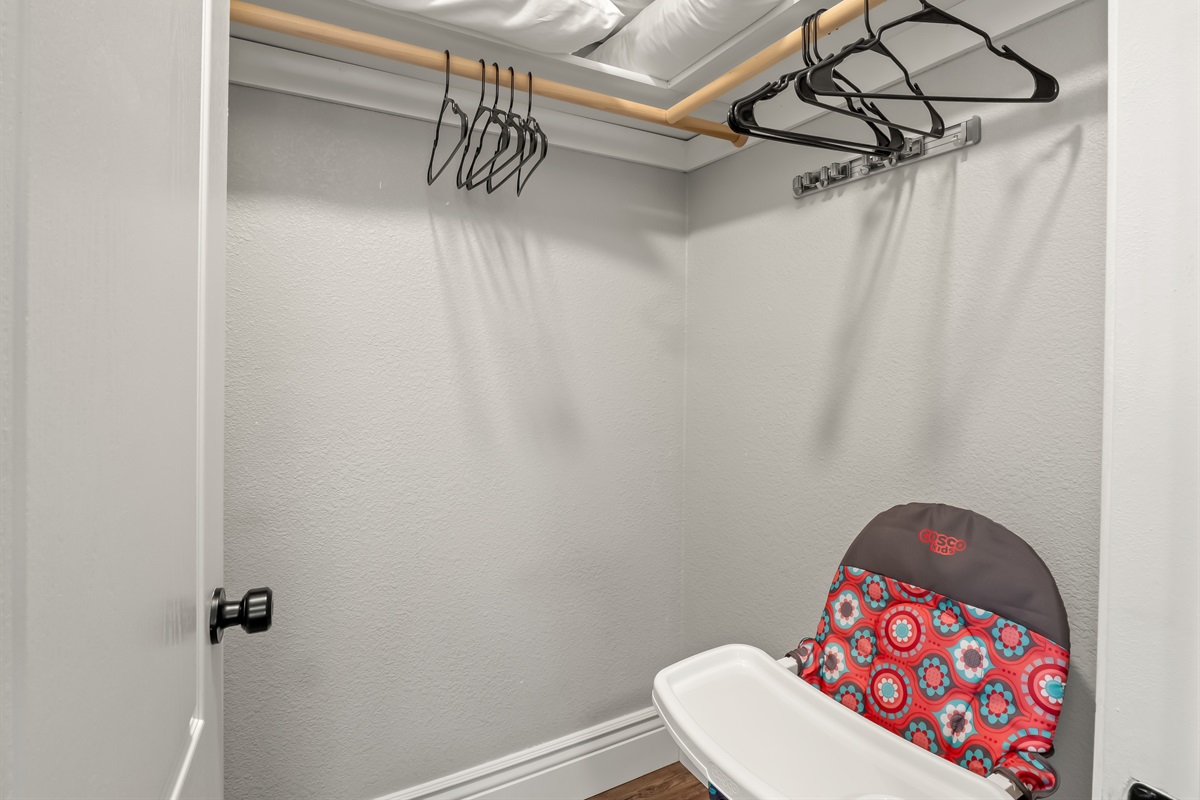 Convenient closet space with hanging rods, extra pillows, and family-friendly essentials—including a high chair for little ones—making travel with kids easier and more comfortable.