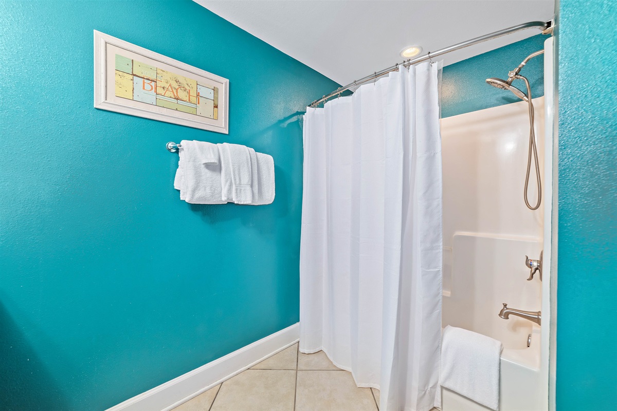 Freshly updated primary bathroom featuring a shower/tub combination, ample vanity space, and modern fixtures.