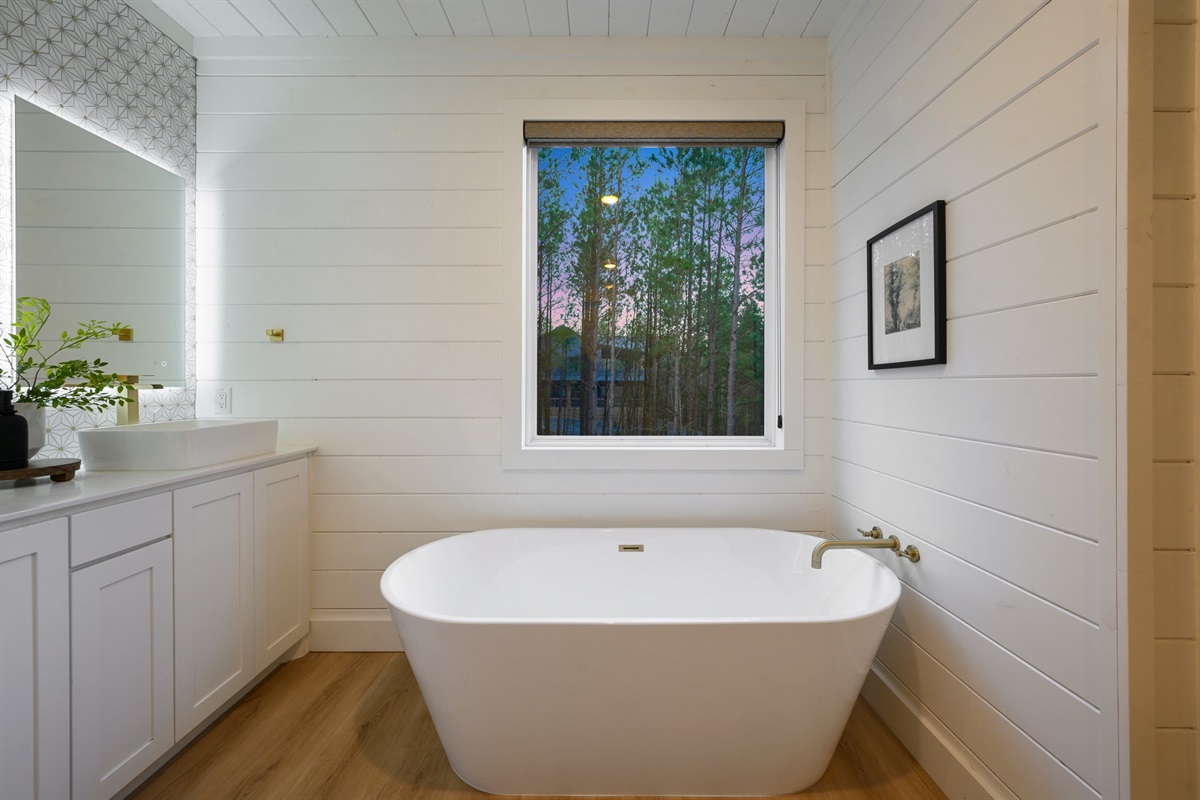 Relax and recharge in the spa-inspired master bath featuring a sleek freestanding soaking tub.