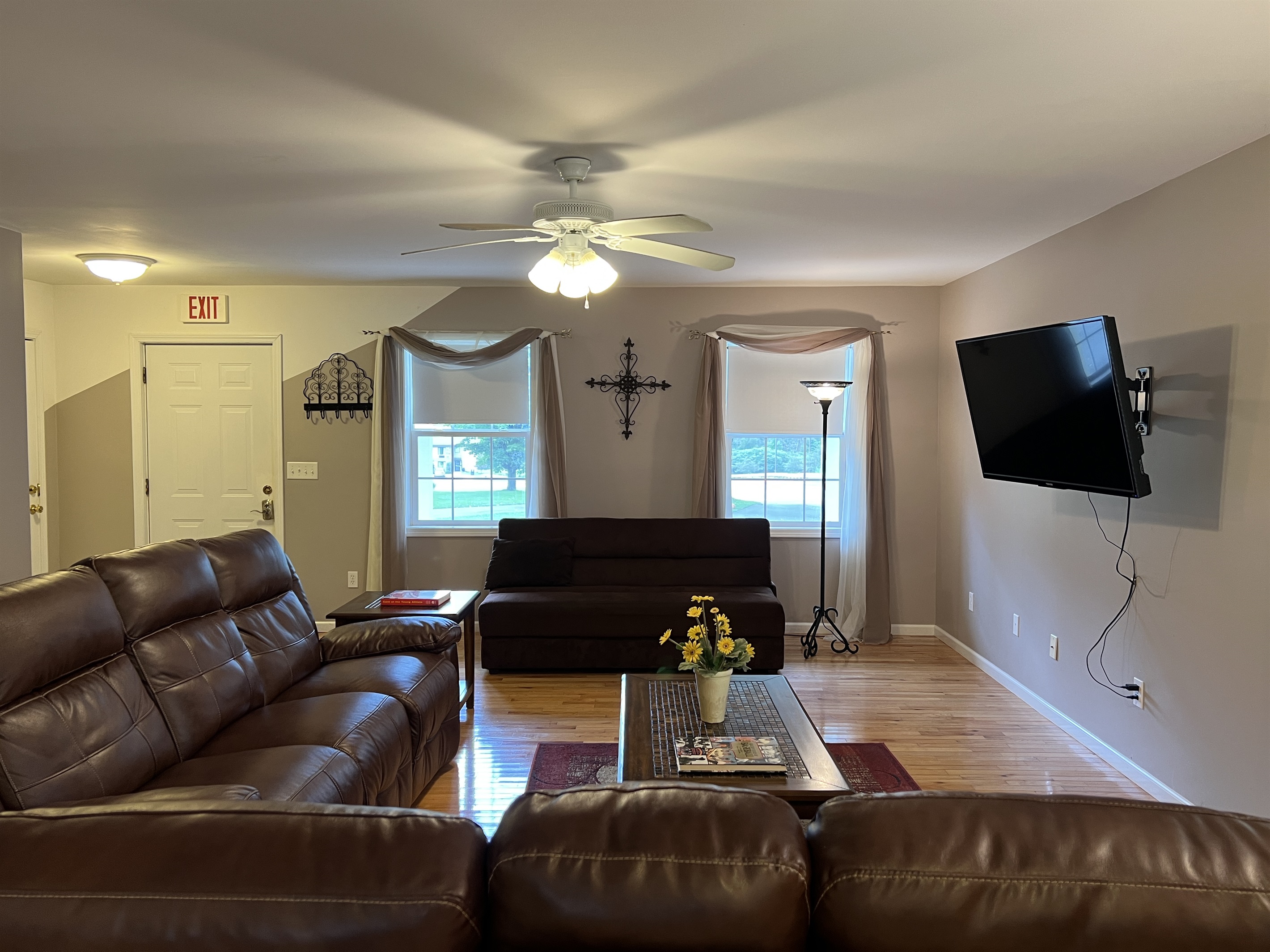 The Federal House Apartment 1 living room with electric recliners and smart TV and a futon for extra sleeping.