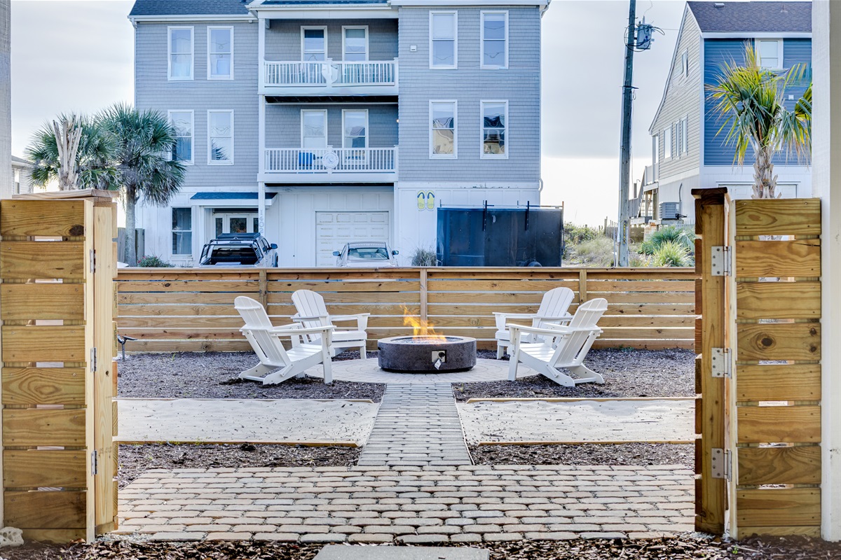 Private fenced backyard with fire pit lounge