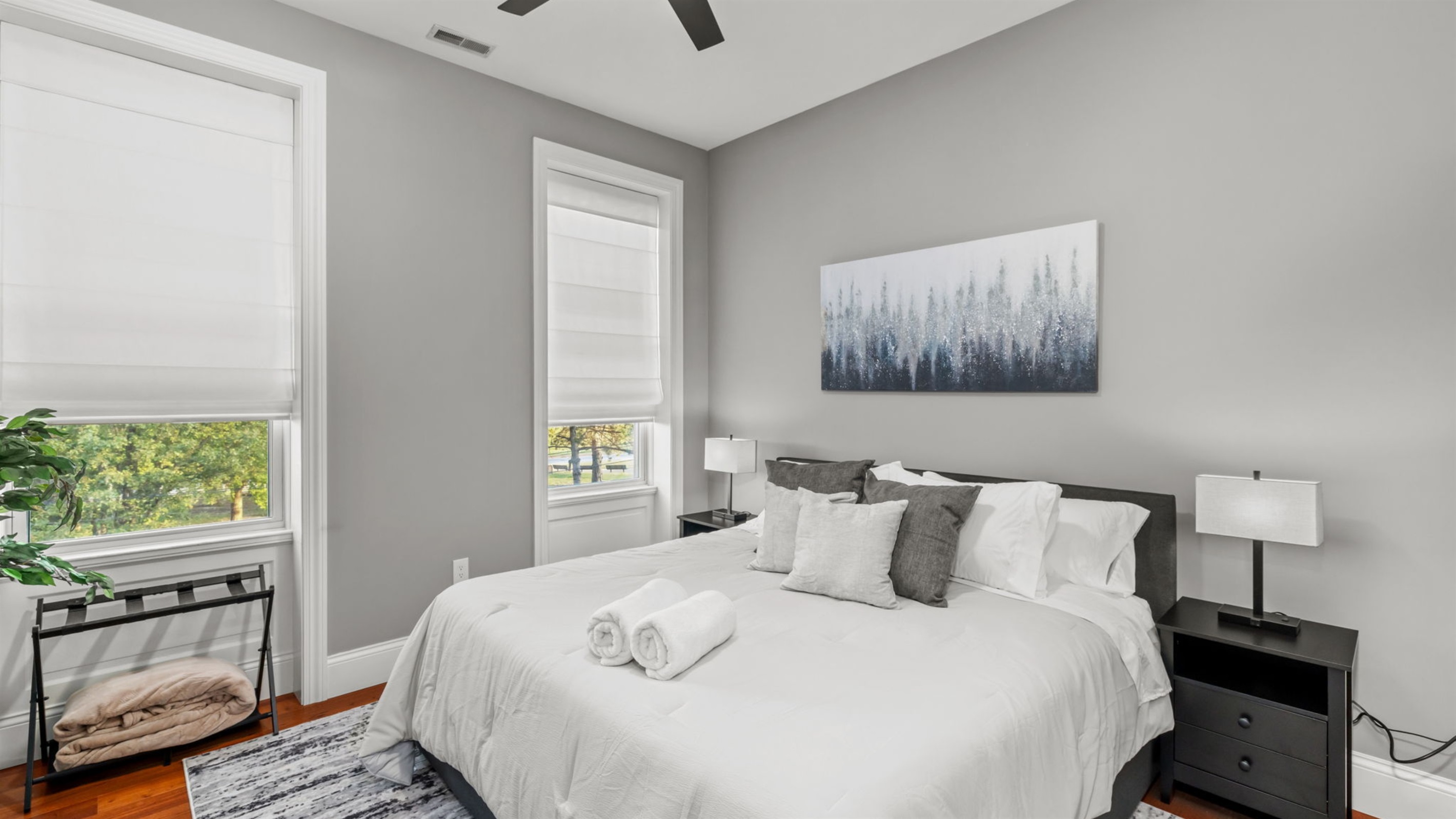 Bedroom 1 is bright and inviting with a king size bed, Smart TV, and spacious closet and dresser.