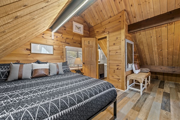 The primary loft suite is private, but does not have doors. It features a king bed, new ROKU TV and private 1/2 bath.  