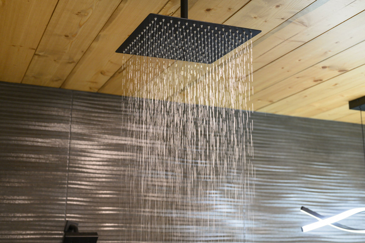  Private en-suite bathroom with a rain shower and serene, luxury-cabin feel.
