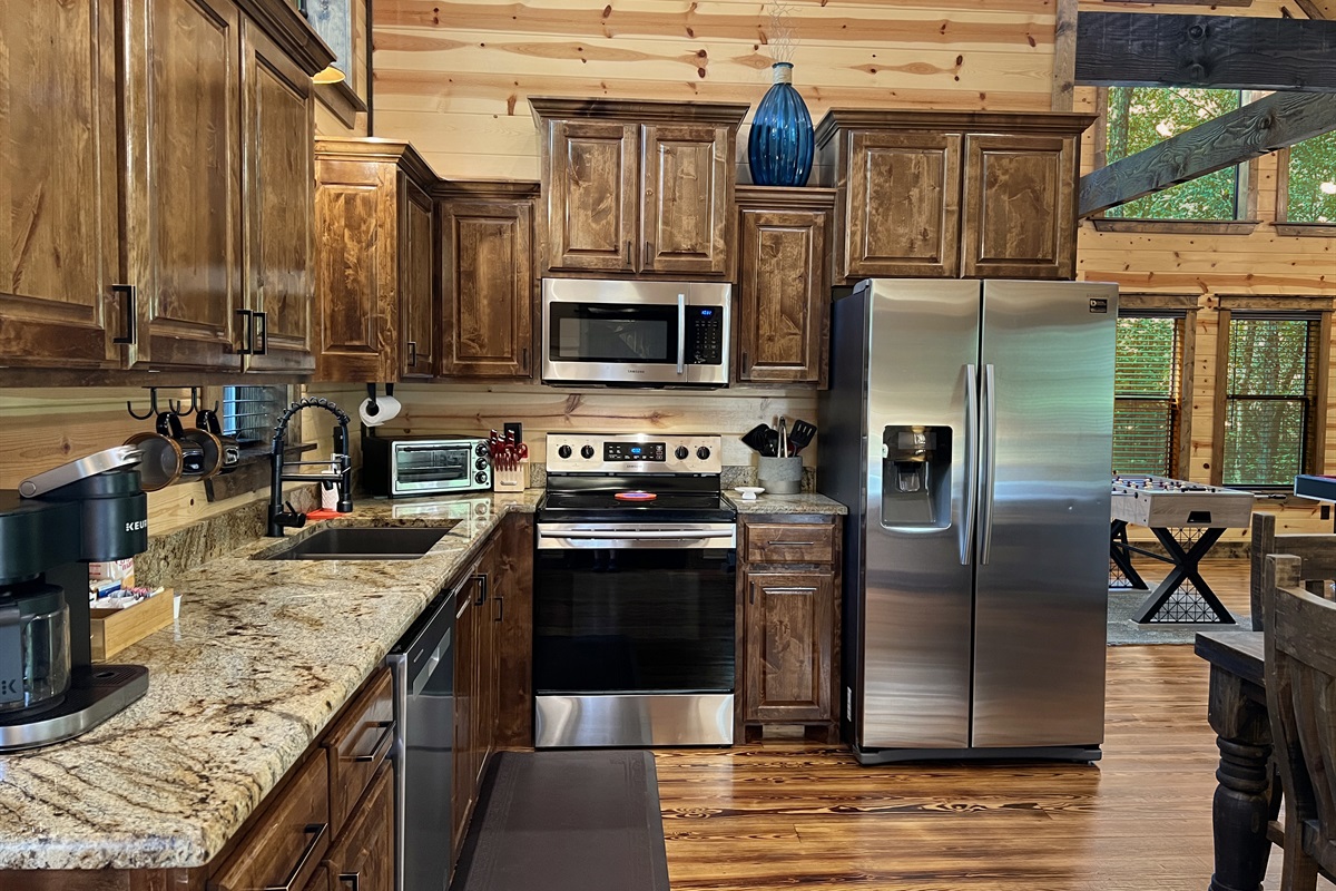 High end appliances and stocked cabinets with everything you need to cook meals.