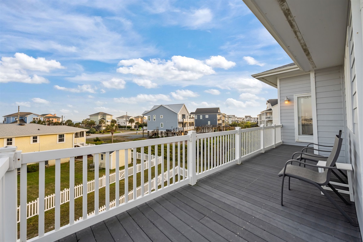 Spacious wraparound balcony with comfortable seating; perfect for enjoying fresh coastal air and peaceful island views
