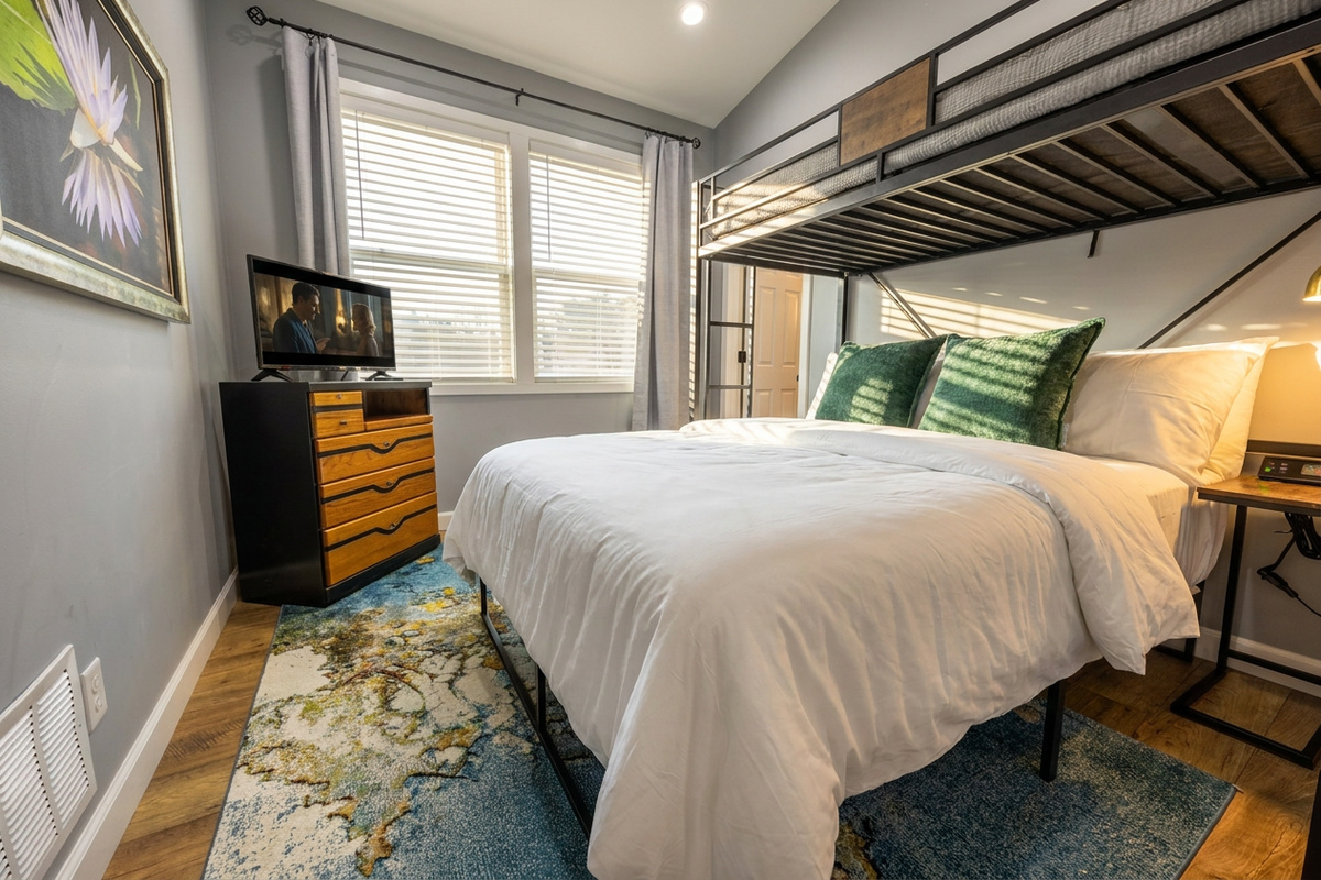 Queen bed with twin loft above. TV, blackout curtains and USB plugs.