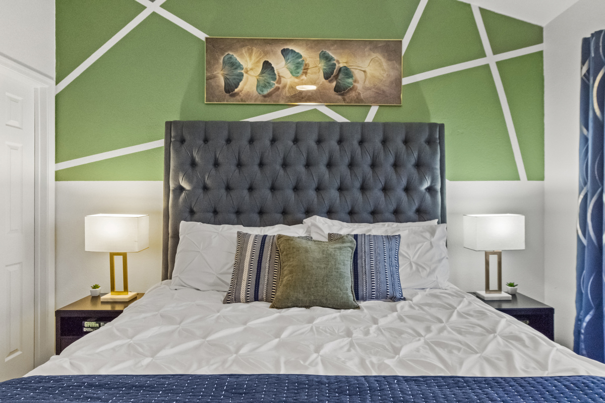 Relaxing bedroom with two bedside tables, a huge window for natural light, and a hybrid mattress for added comfort. 