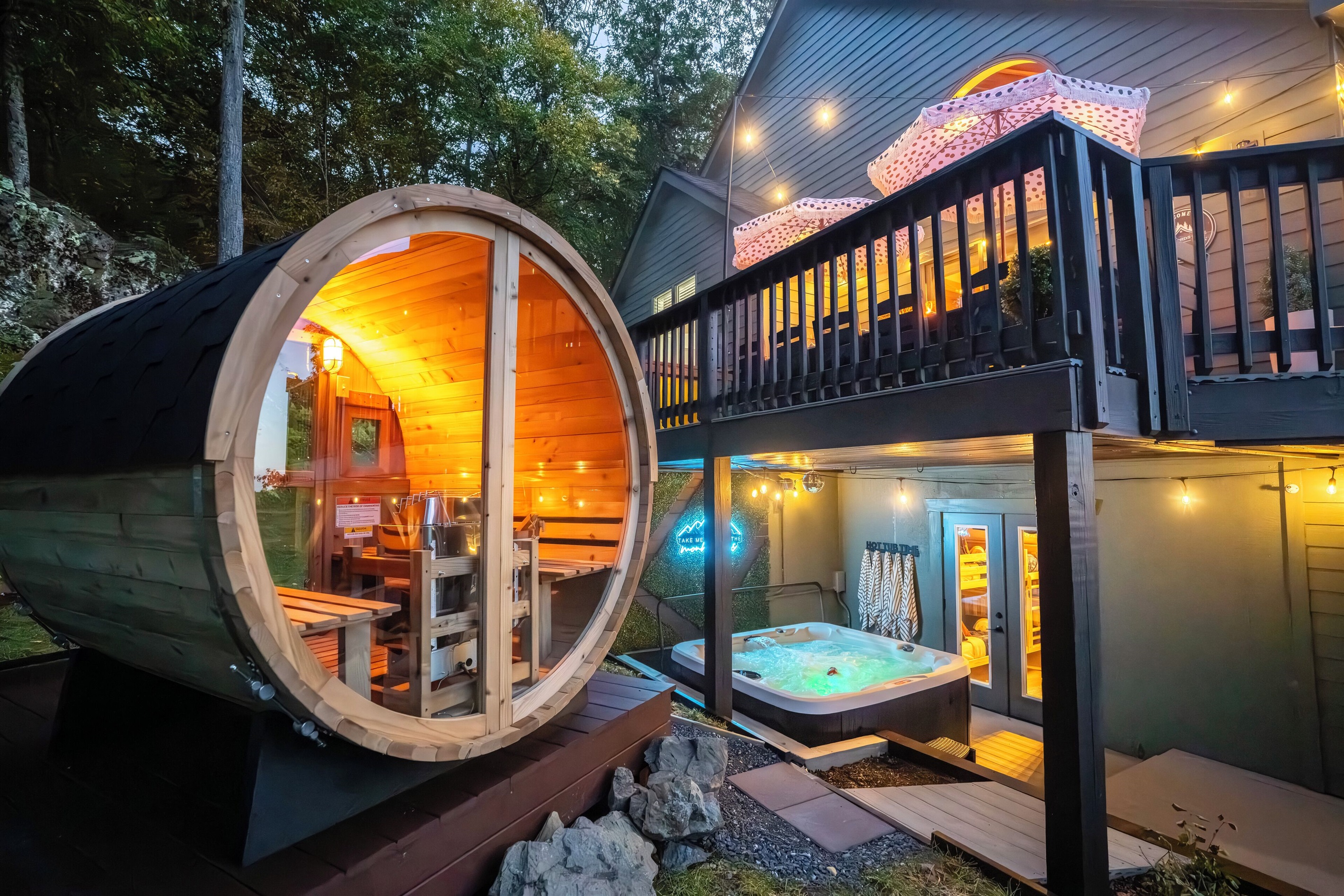 Barrel sauna with panoramic viewing window and hot tub