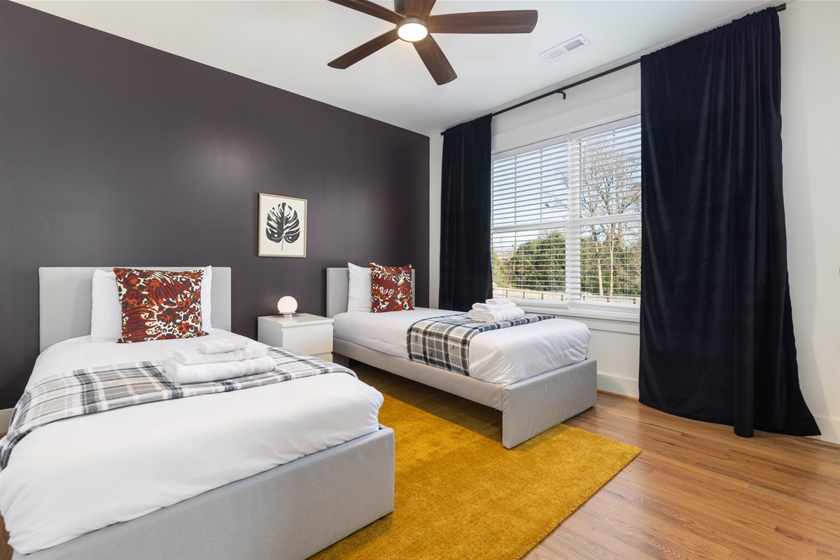The upstairs twin bedroom has luxury sheets, extra blankets and pillows, and luxurious velvet blackout curtains.