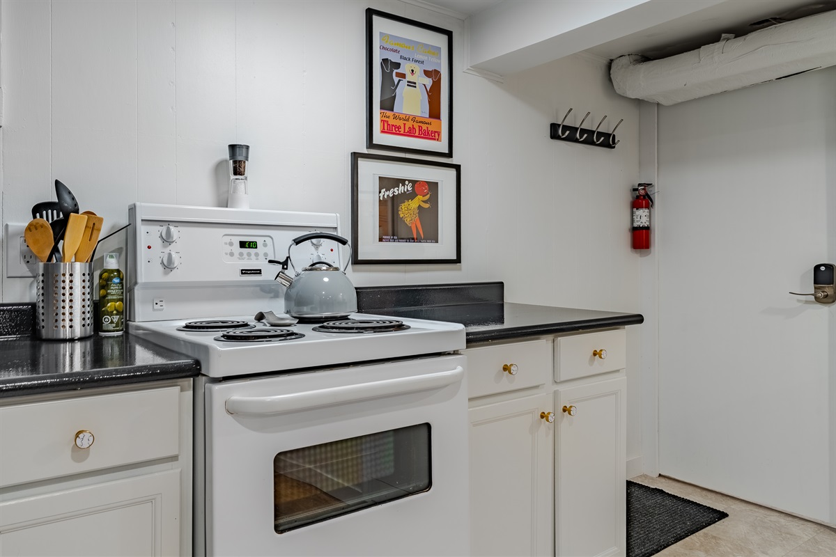 Basic cooking setup with stove, cookware, and dishware for simple meals.