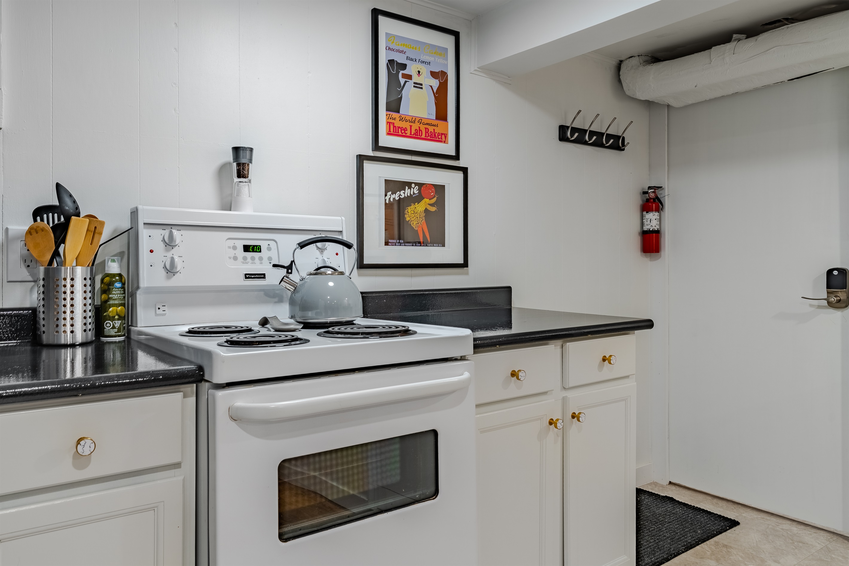 Basic cooking setup with stove, cookware, and dishware for simple meals.