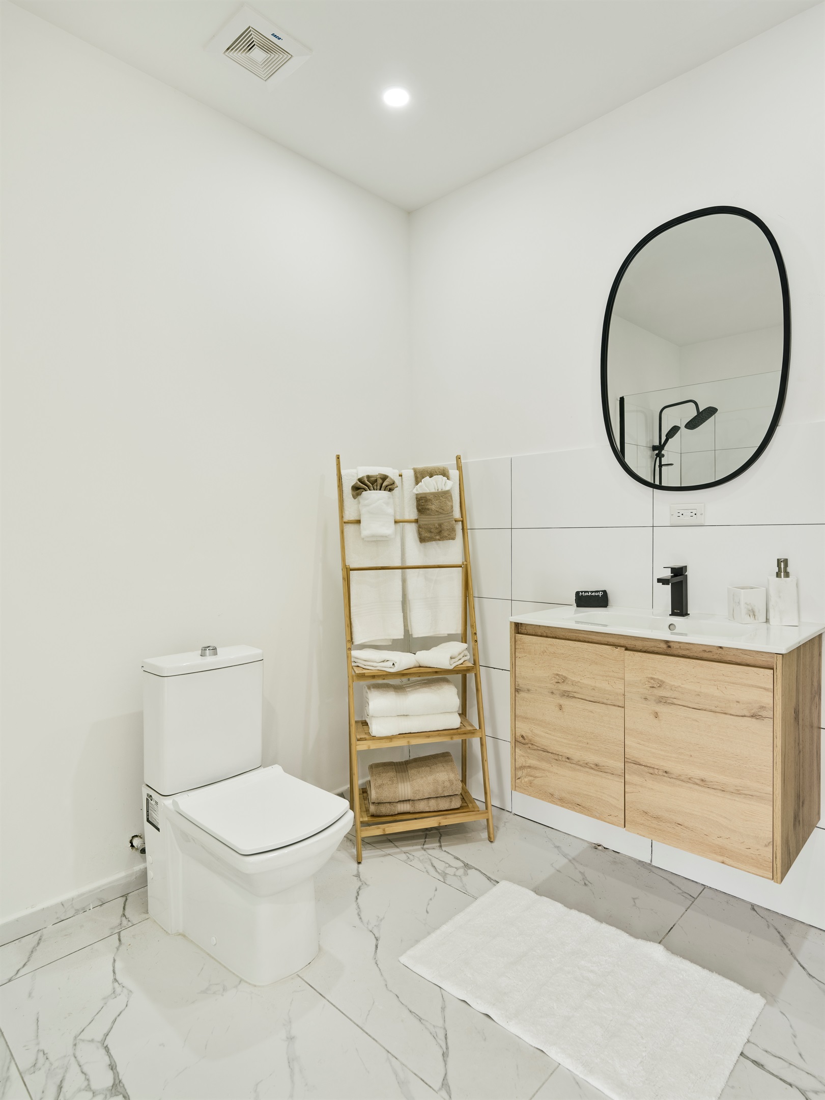 Cozy Half Bath with Modern Toilet & Wooden Ladder Towel Rack