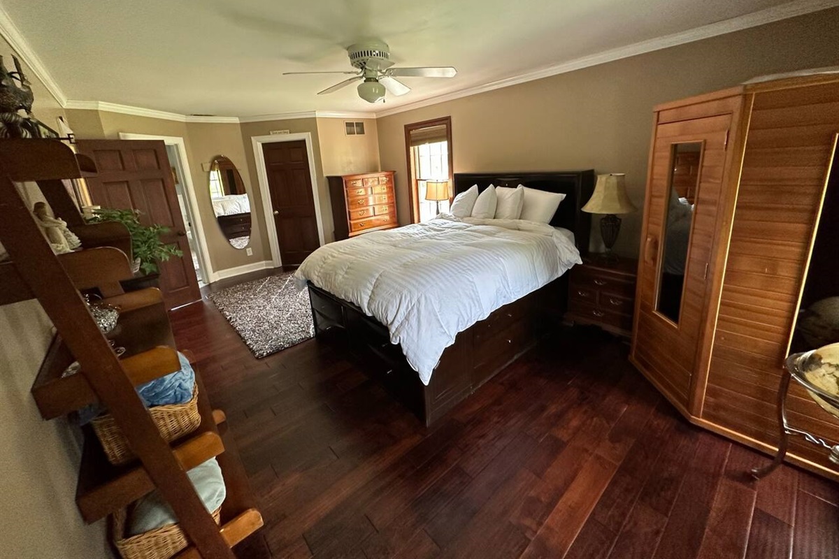 Master bedroom (BR1) with Queen Bed. The wood enclosure is a working Suana.