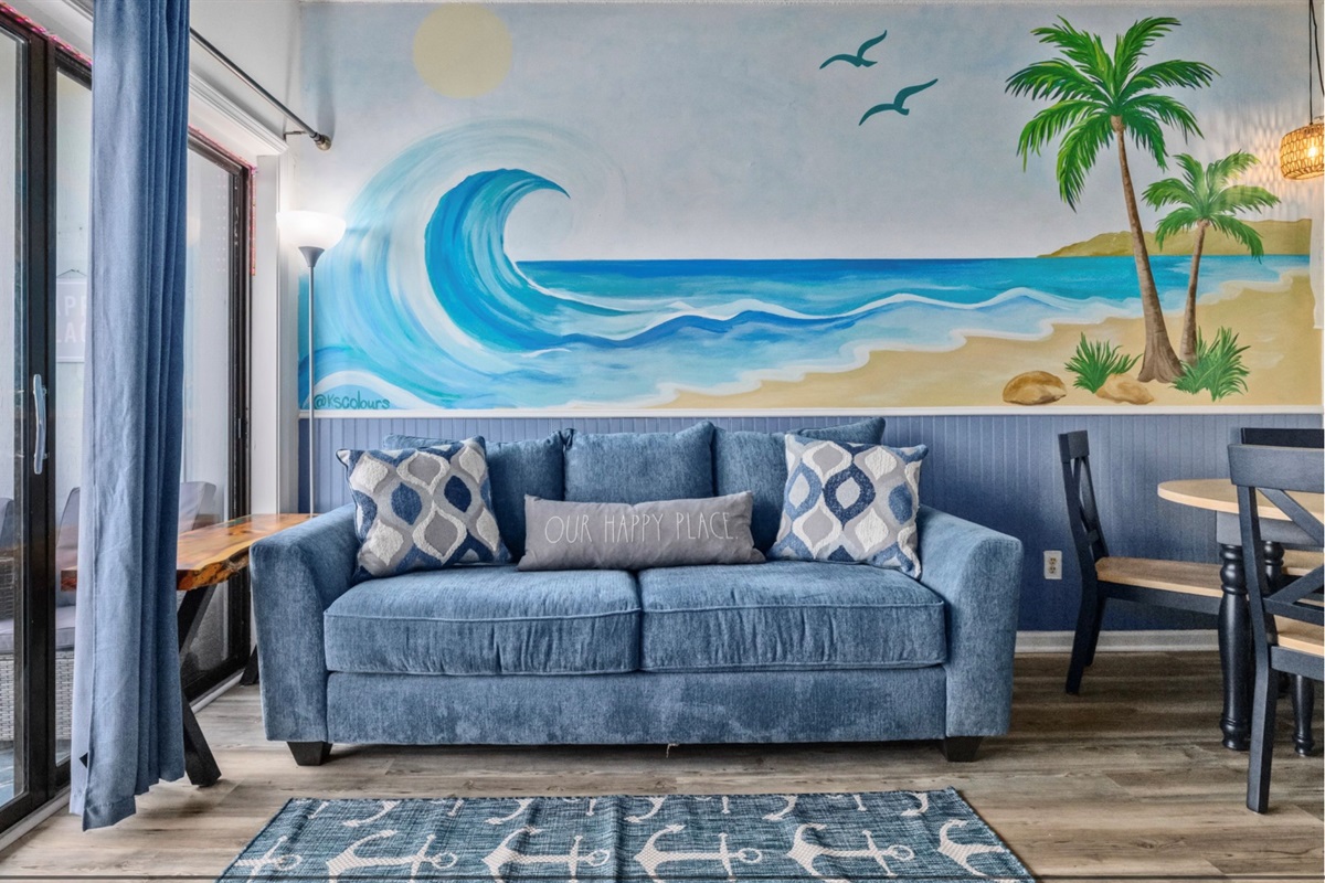 Sink into coastal comfort beneath a hand-painted ocean mural 🌊
Plush lounge seating, calming beach tones, and a space designed to unwind, reconnect, and fully slip into vacation mode.