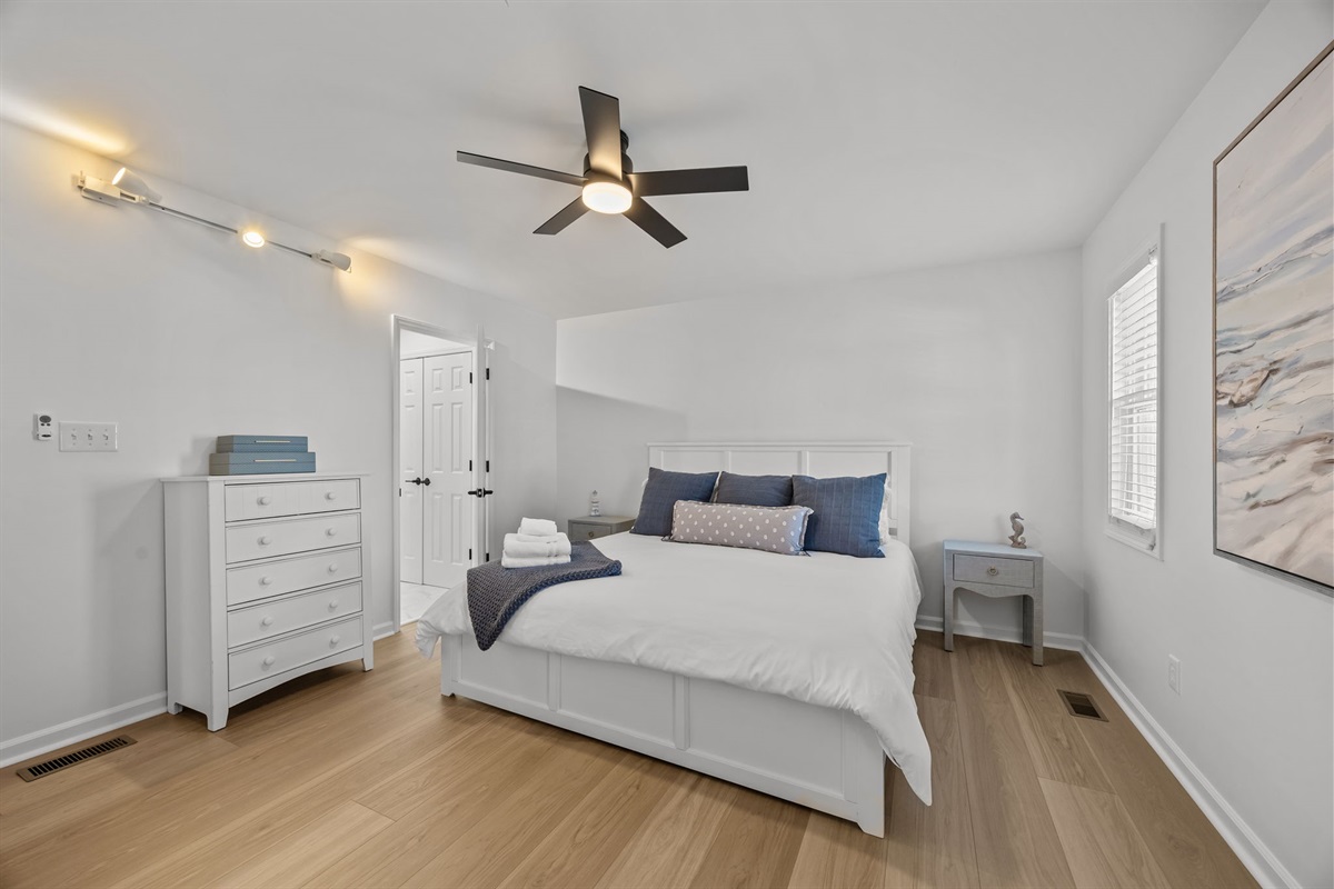 First floor master bedroom with king bed, TV, and ensuite bathroom