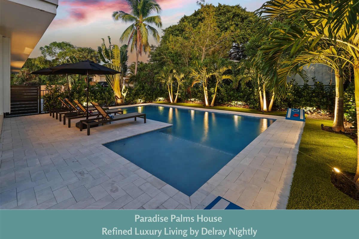 Serene Delray Beach retreat with a private pool, palm trees, ambient lighting, and chic loungers—perfect for relaxing nights.