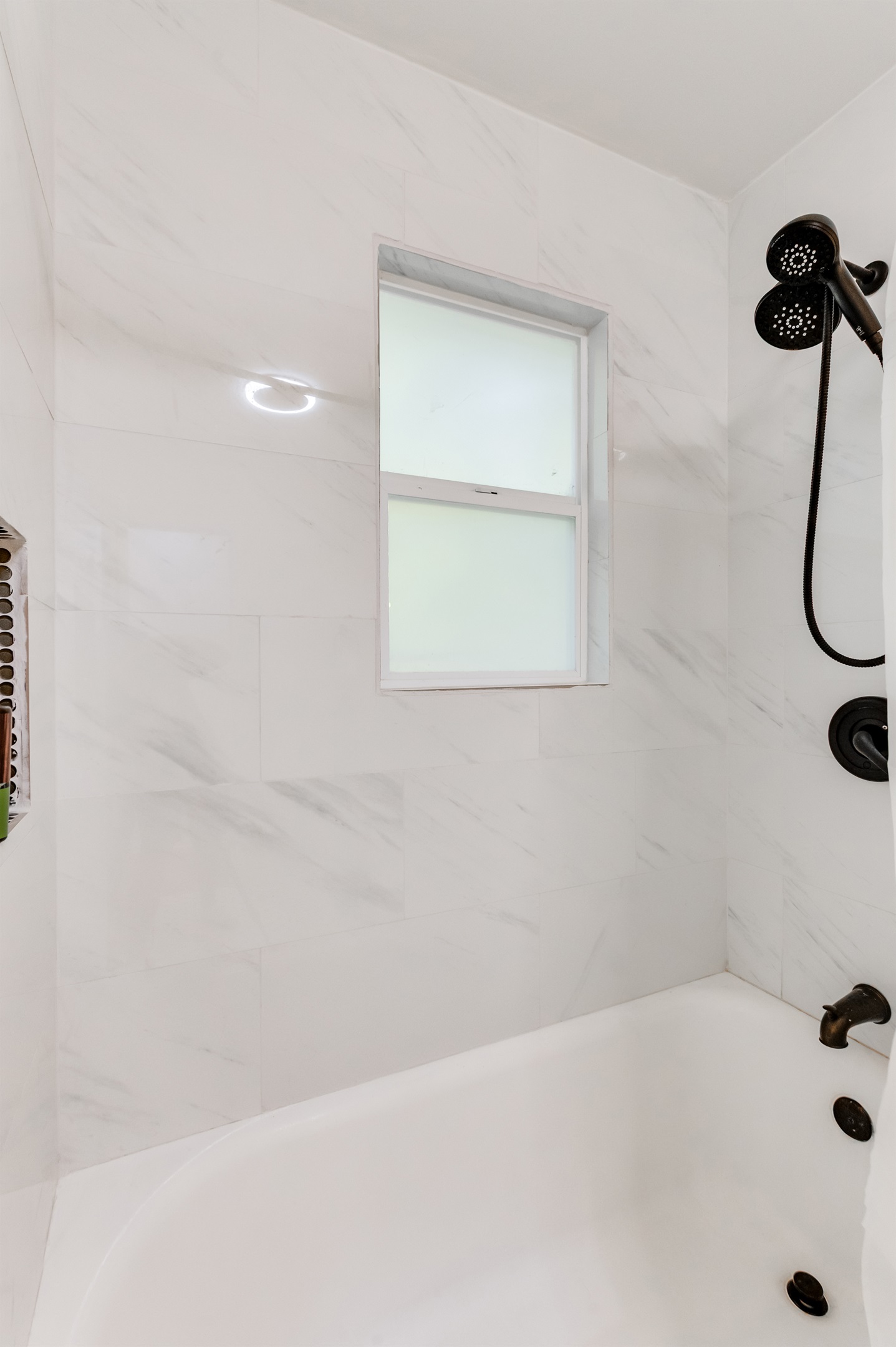 Upstairs Full Bathroom 1: Sleek marble tiles and modern fixtures create a refreshing retreat for your stay!