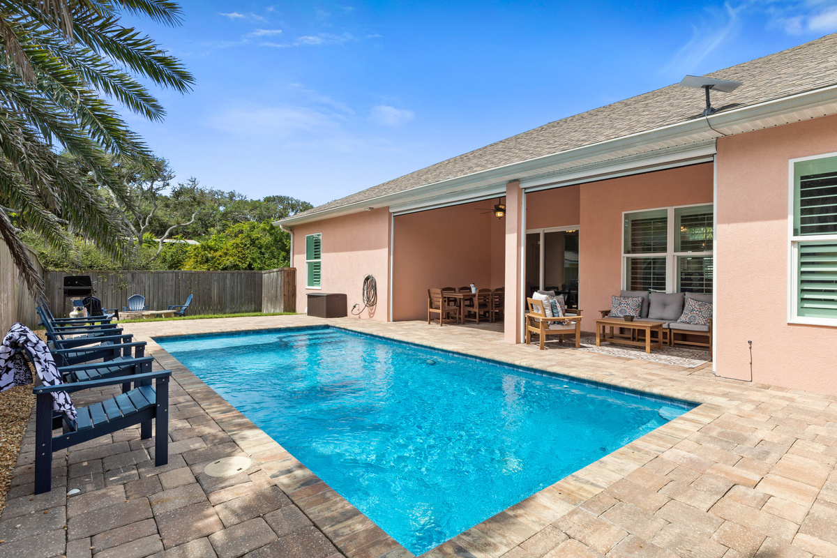 Poolside you can see the shaded lanai table and lounge seating, perfect for lunch in swimsuits between dips.