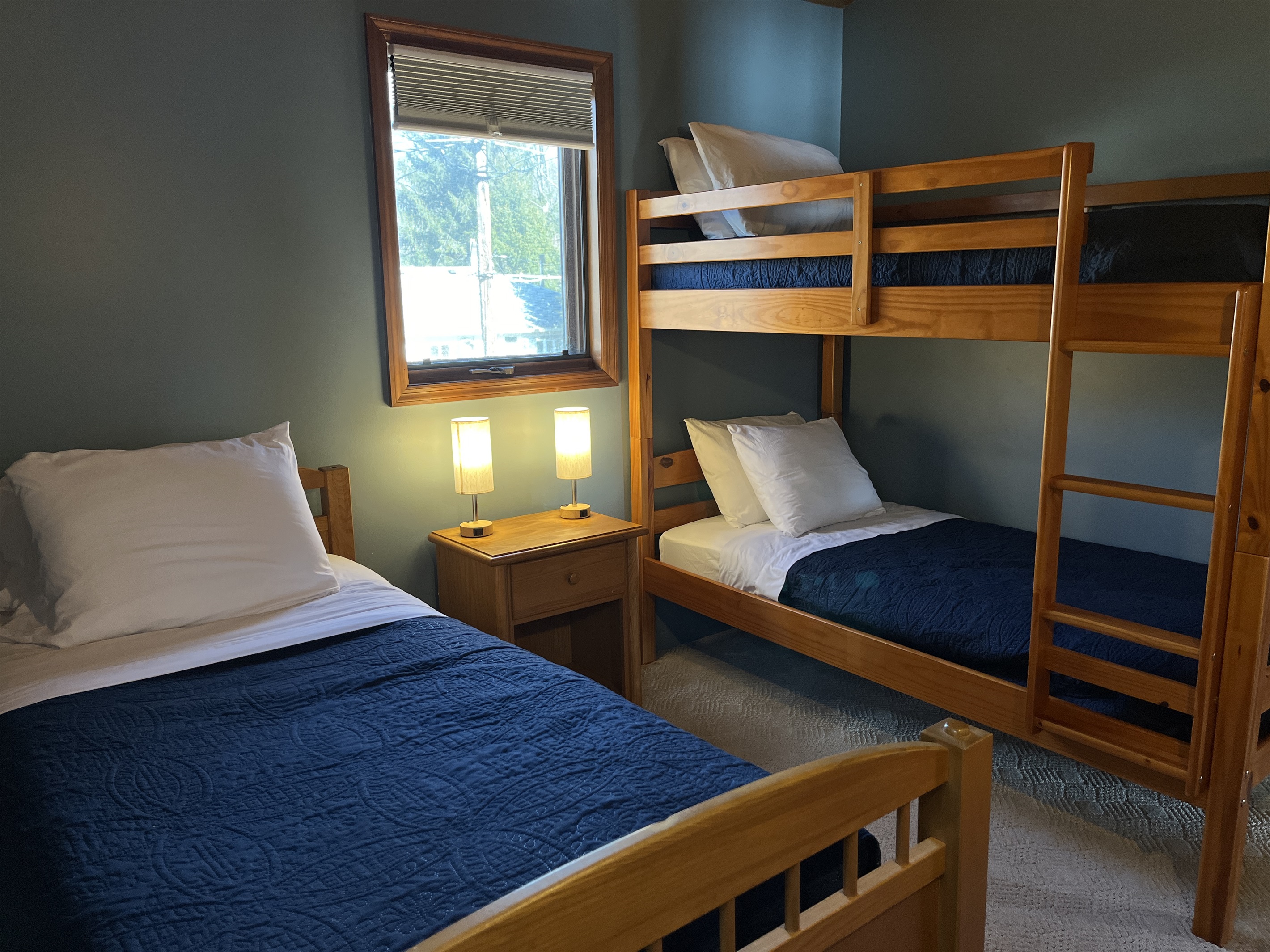 Camp Havon 2nd floor bunk room with one bunkbed and one stand alone twin bed.